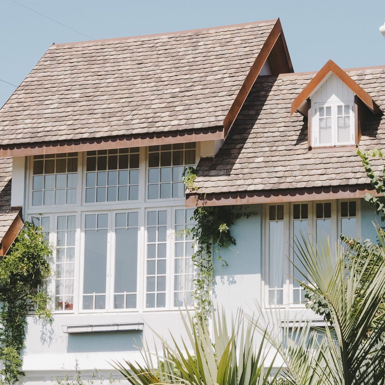 Home with a newly shingled roof against a blue sky